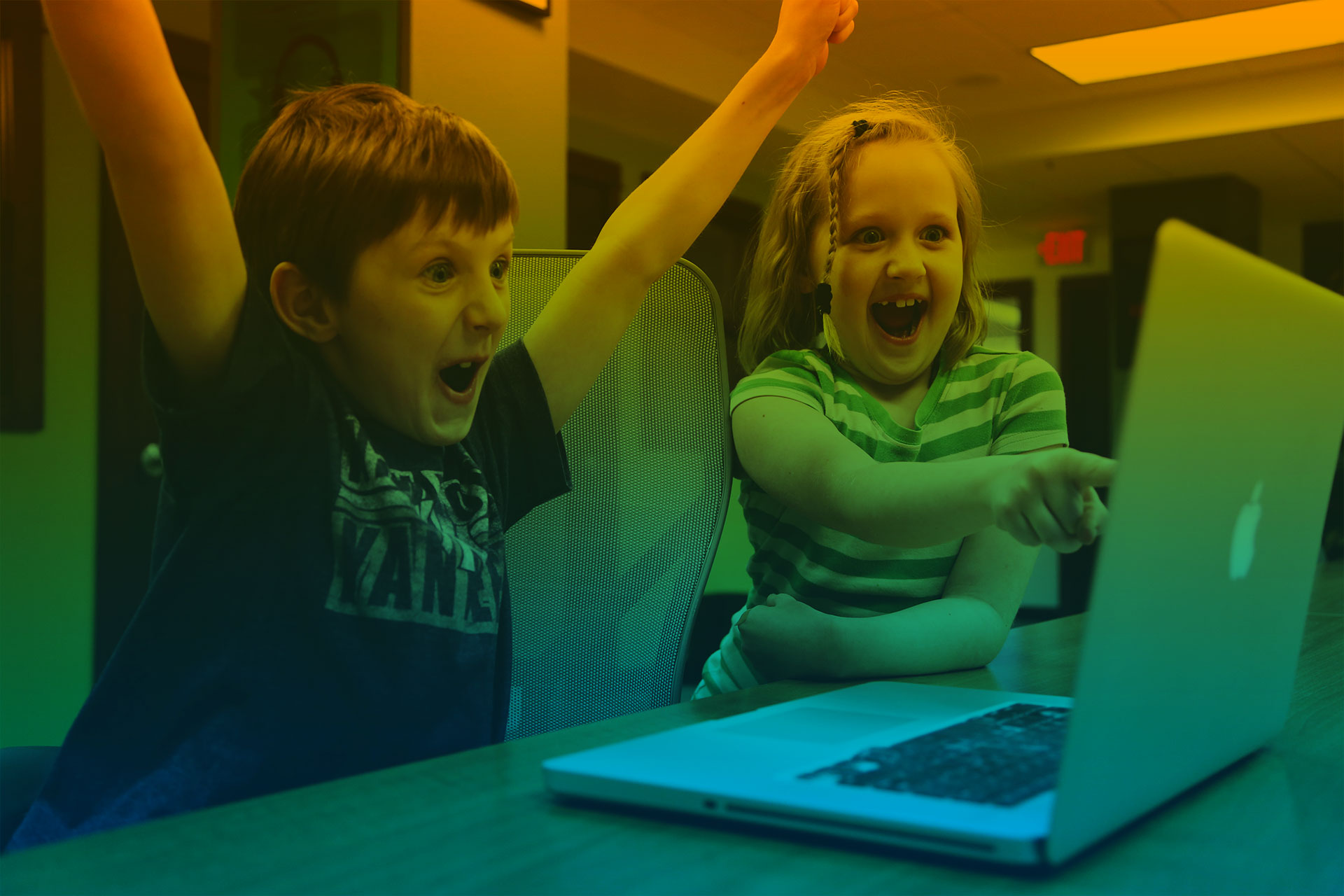 Article Cover Image: Two children excited by something on a laptop screen