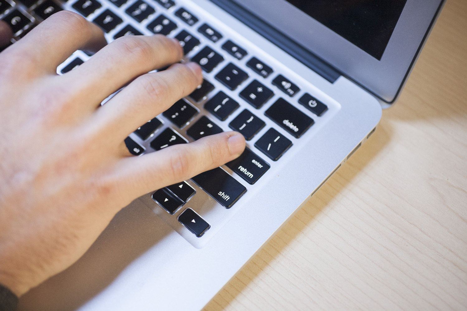 photo of hands using a laptop