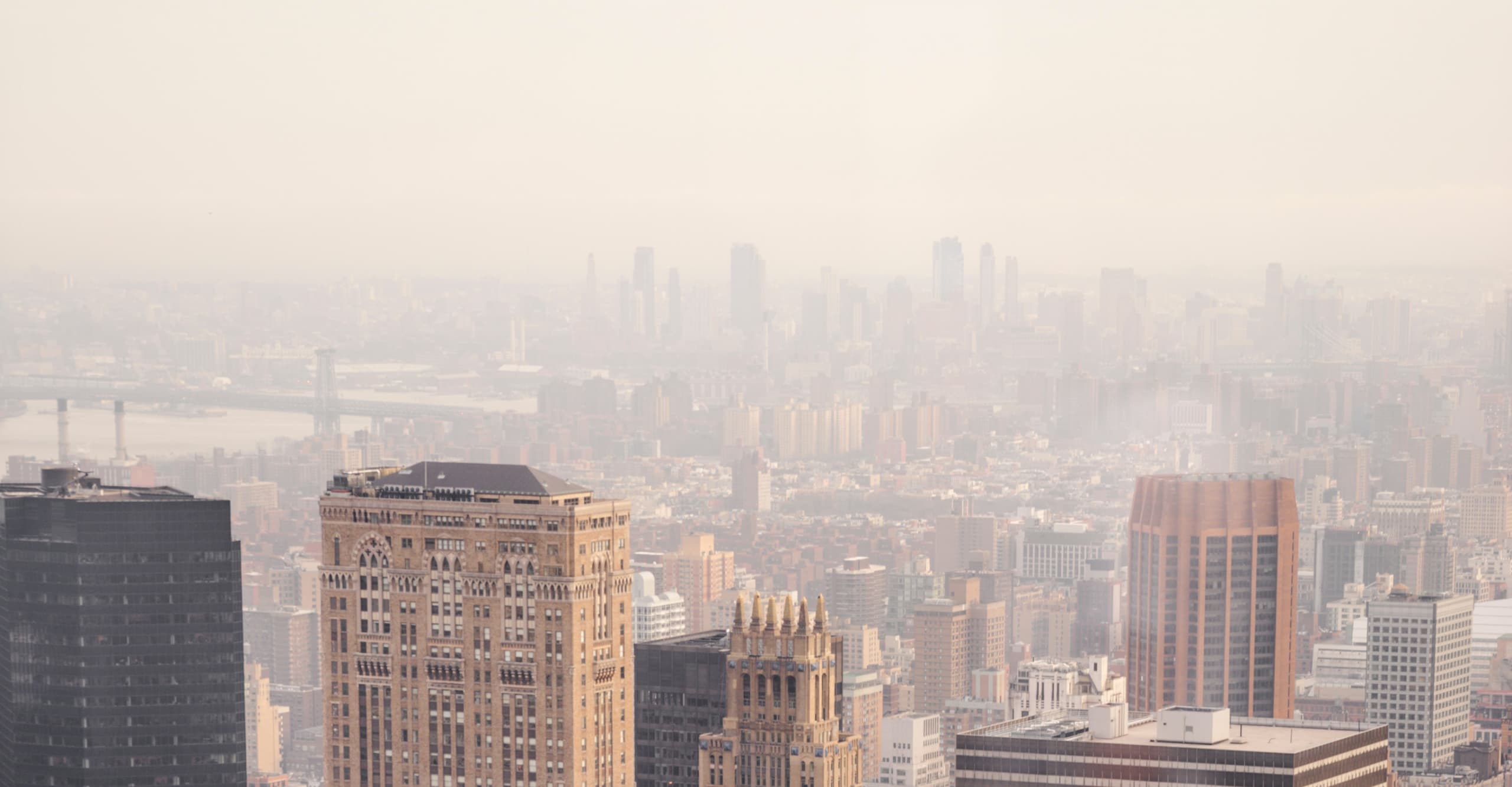 A view of a city with an overhanging smog