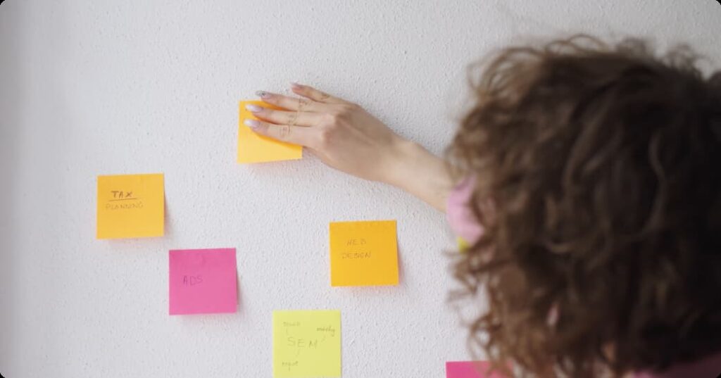 Photo of woman using sticky notes to create a strategy